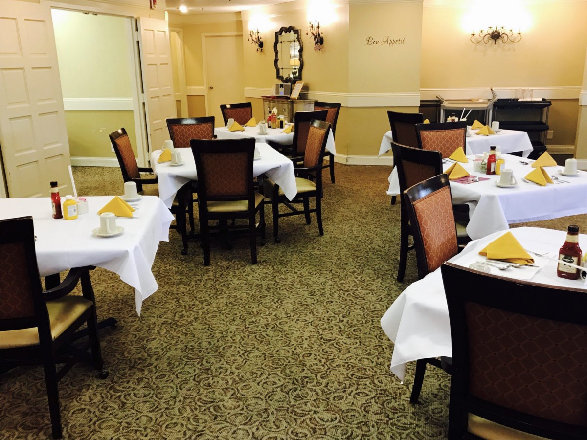 A neatly arranged dining area with tables set for guests.