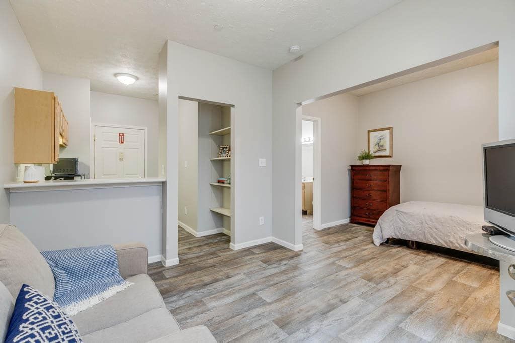 Modern interior with an open-plan layout featuring both a living area and a bedroom.
