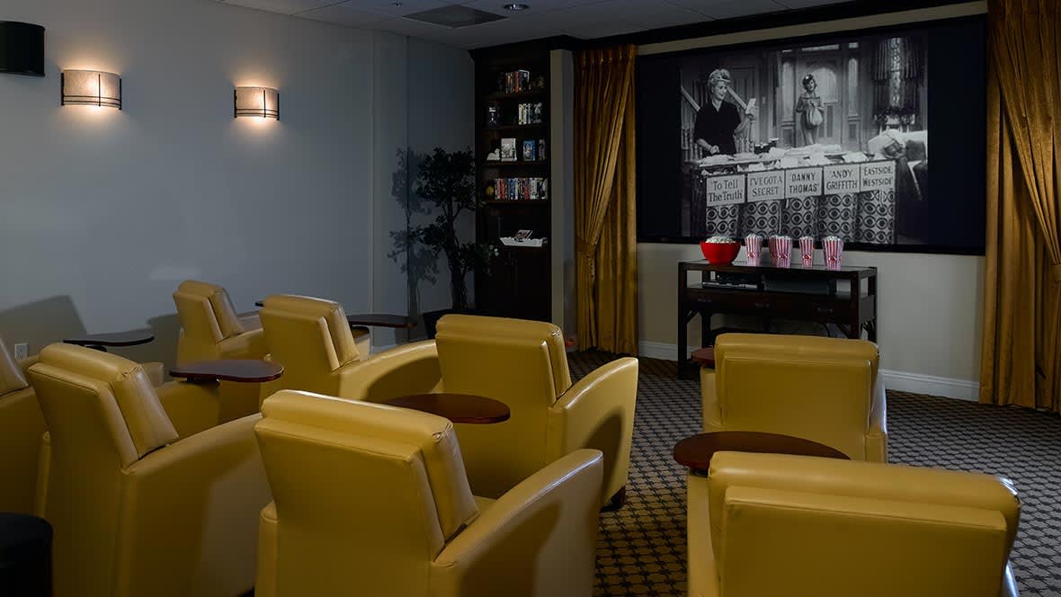 A cozy home theater setup with comfortable seating and a classic movie playing on the screen.