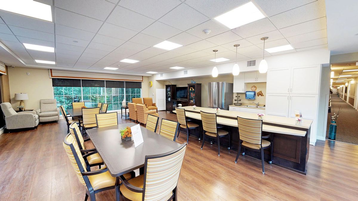A spacious and modern kitchen with a dining area featuring ample seating and bright lighting.