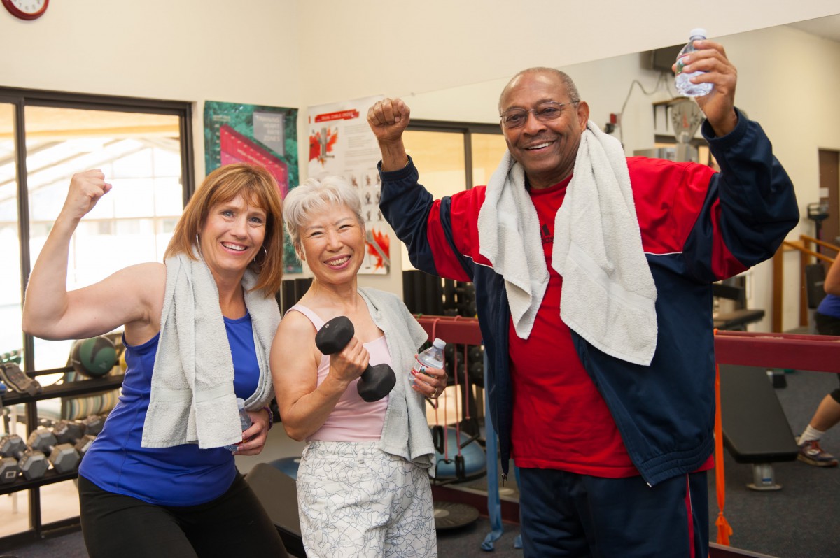 A group of seniors enjoying a workout session together at the gym.