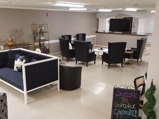 A cozy lounge area with comfortable seating and a television welcoming guests.