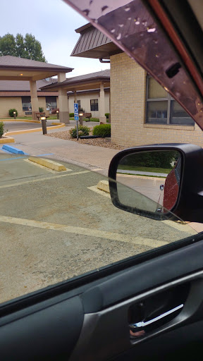A view of a parking lot reflected in the side mirror of a car.