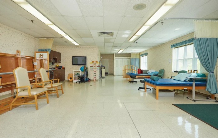 A spacious therapy room equipped for physical rehabilitation.