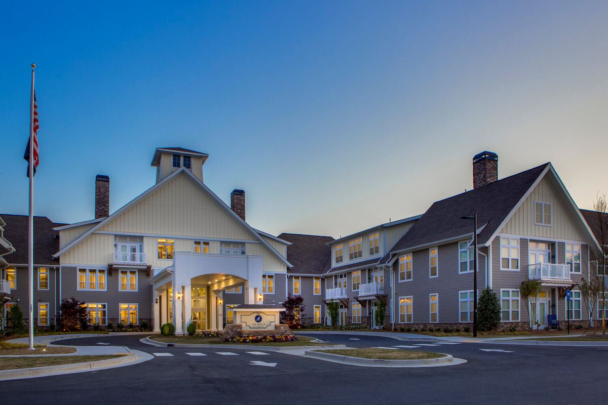 A modern hotel building with a welcoming entrance during the evening.