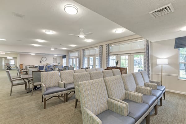 A bright and modern waiting area with comfortable seating and large windows.