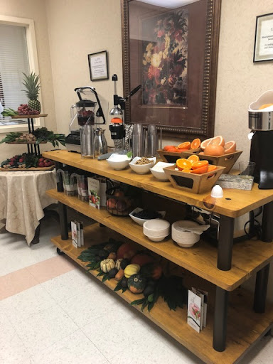 A cozy breakfast bar setup featuring a variety of fresh fruits and beverage options.