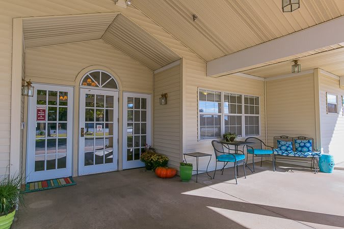 A welcoming outdoor porch with seating and seasonal decorations.