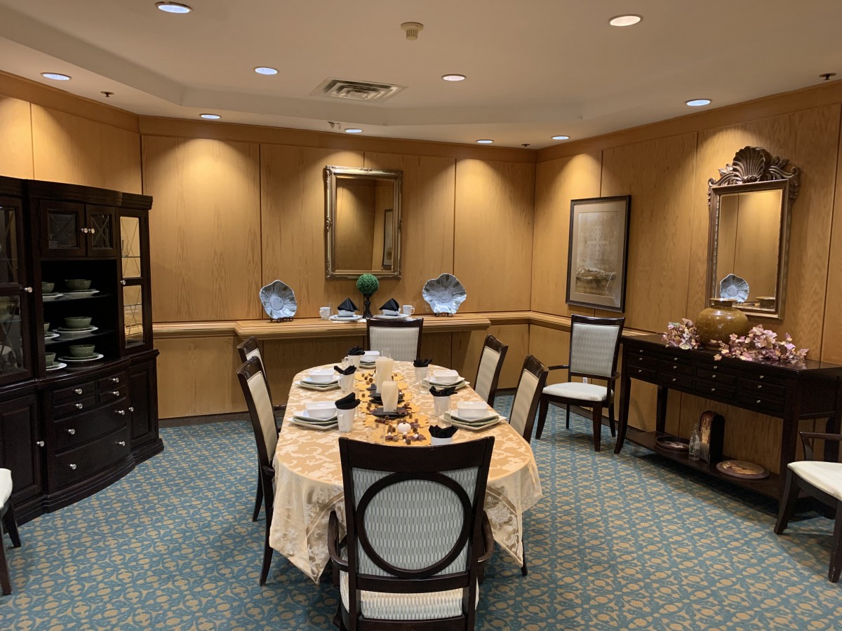 An elegantly set dining room table with a formal and sophisticated ambiance.