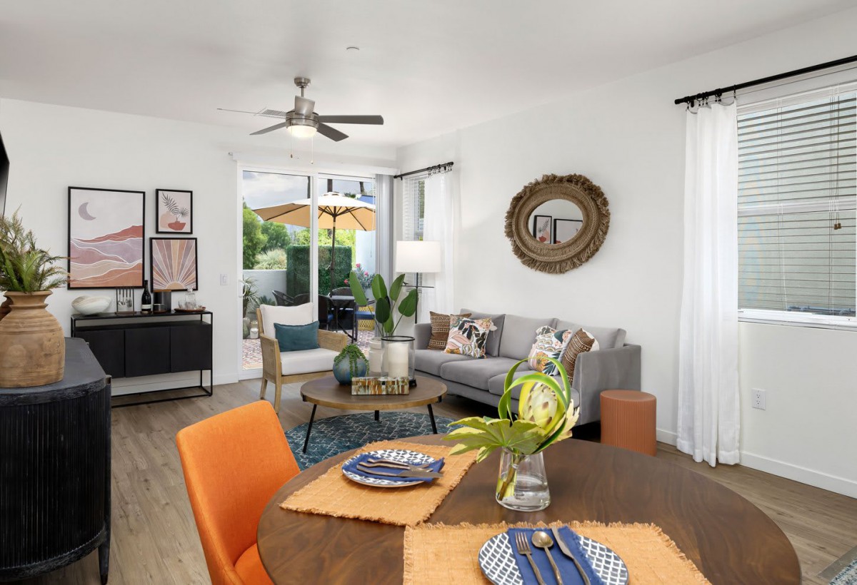 A modern living and dining area with stylish furniture, ample natural light, and tasteful decor.