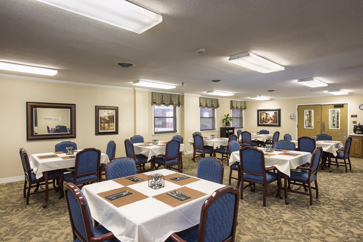 An elegant dining room with neatly arranged tables and chairs.
