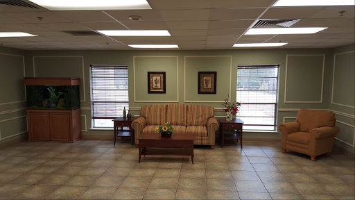 A cozy waiting area featuring a comfortable sofa and decorative artwork.