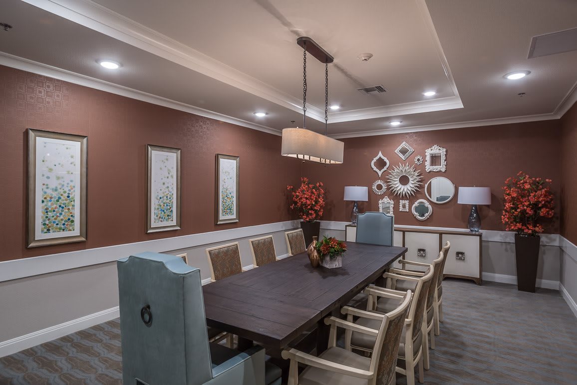 A modern dining room with elegant decor and ambient lighting.