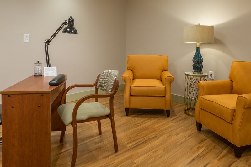 A cozy office space featuring comfortable chairs and a wooden desk.