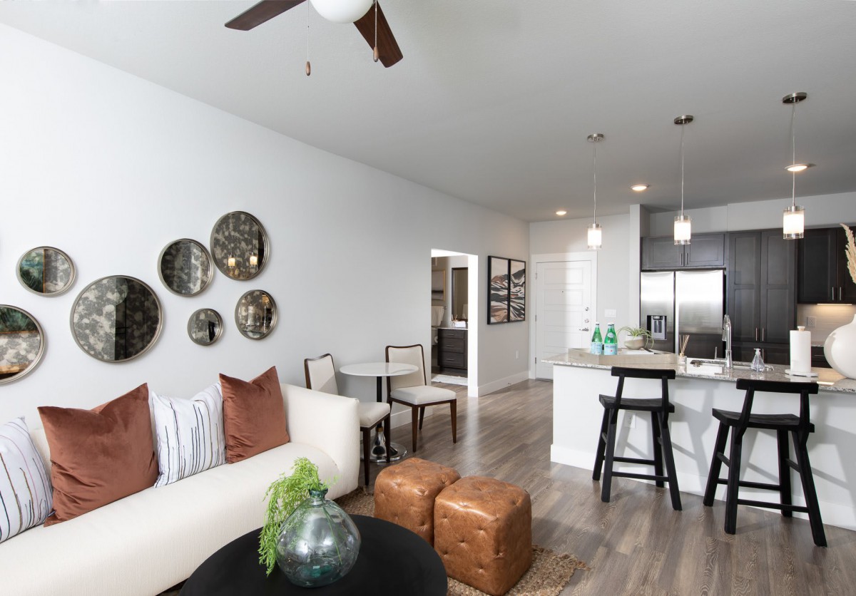 A modern open-concept living and kitchen area with stylish decor and neutral tones.