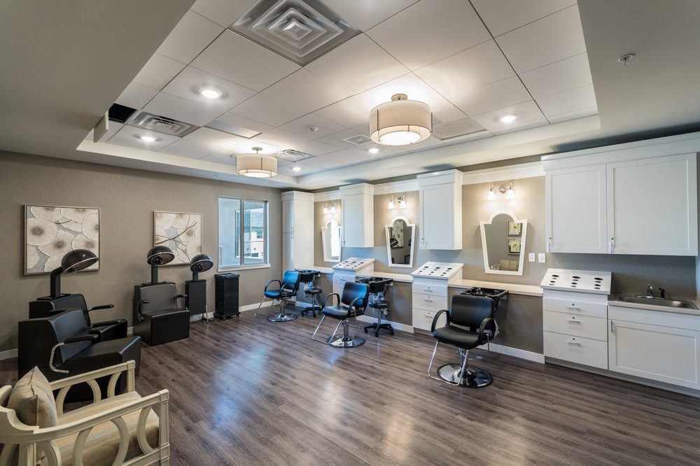 A modern salon interior with stylish chairs and mirrors.