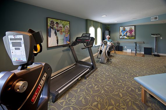A small fitness room equipped with treadmills and exercise machines.