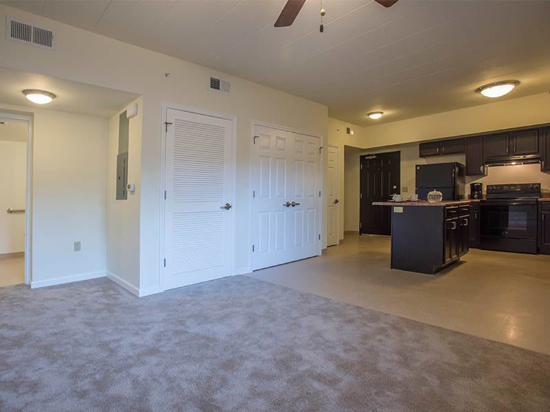 A modern apartment interior with an open living area and kitchen.