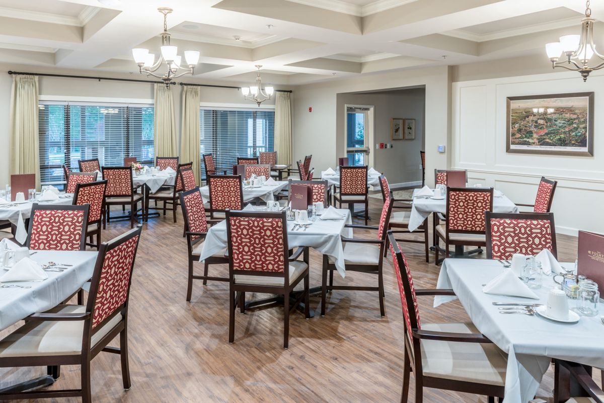 An elegant restaurant dining room with neatly arranged tables and chairs.