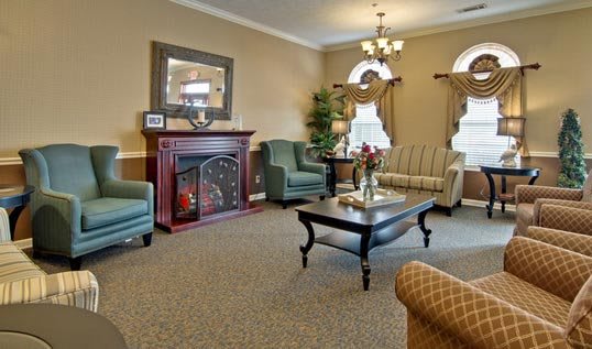 A cozy living room with elegant furniture and a warm fireplace.