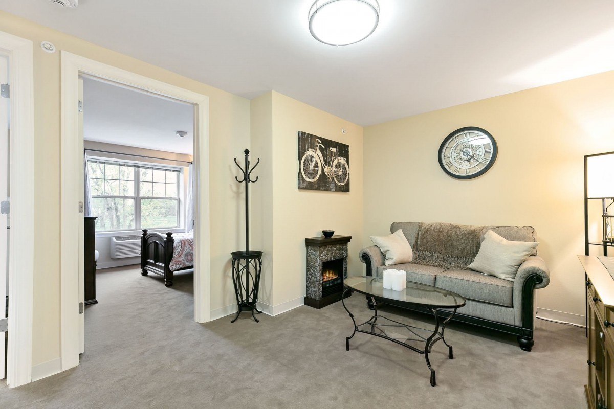 Cozy living room with modern decor featuring a comfortable sofa, glass coffee table, and stylish wall art.