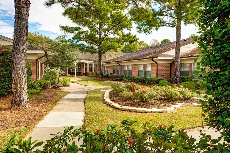 A serene residential complex with well-maintained gardens and pathways.