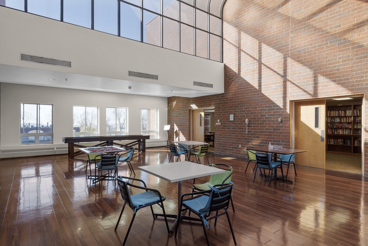 A modern dining area with large windows and ample natural light.