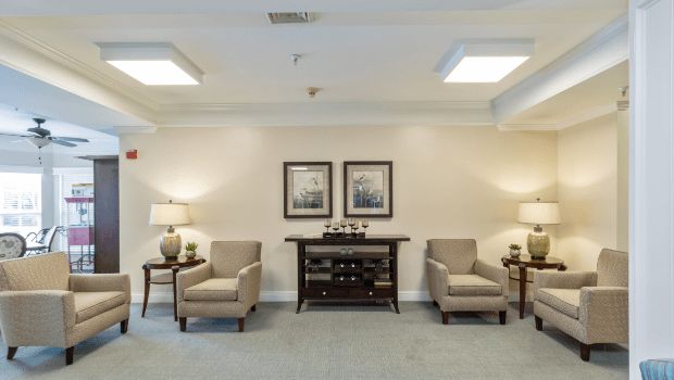A well-lit living room with comfortable chairs and decorative elements.