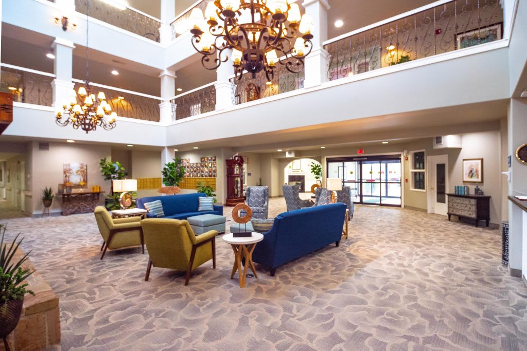 A spacious and elegantly decorated lobby with comfortable seating and chandeliers.