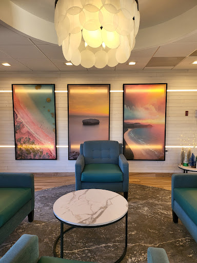 A stylish lounge area featuring modern furniture and vibrant abstract artwork.