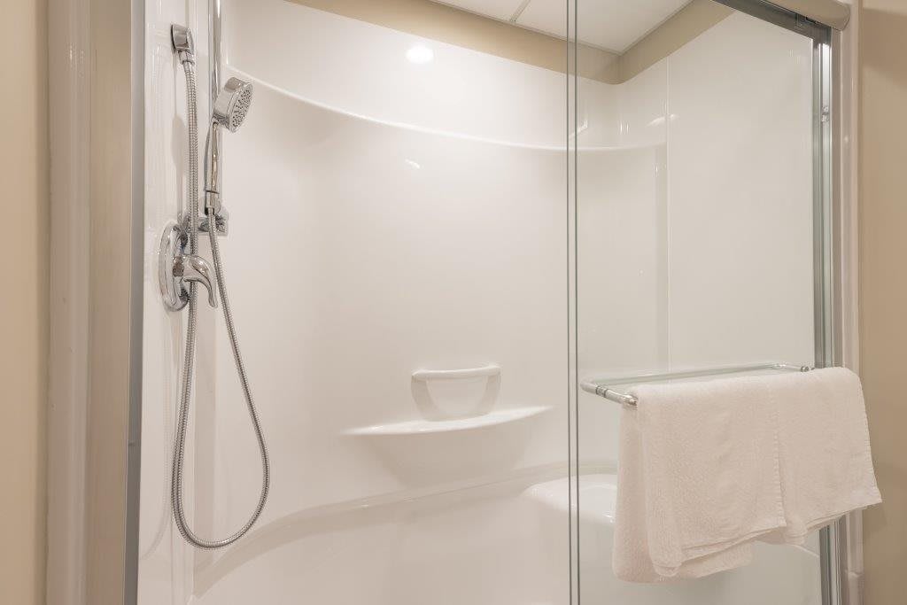 A modern bathroom with a glass-enclosed shower and sleek design.