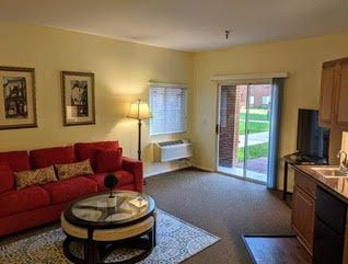 Cozy living room with a red sofa and modern decor.