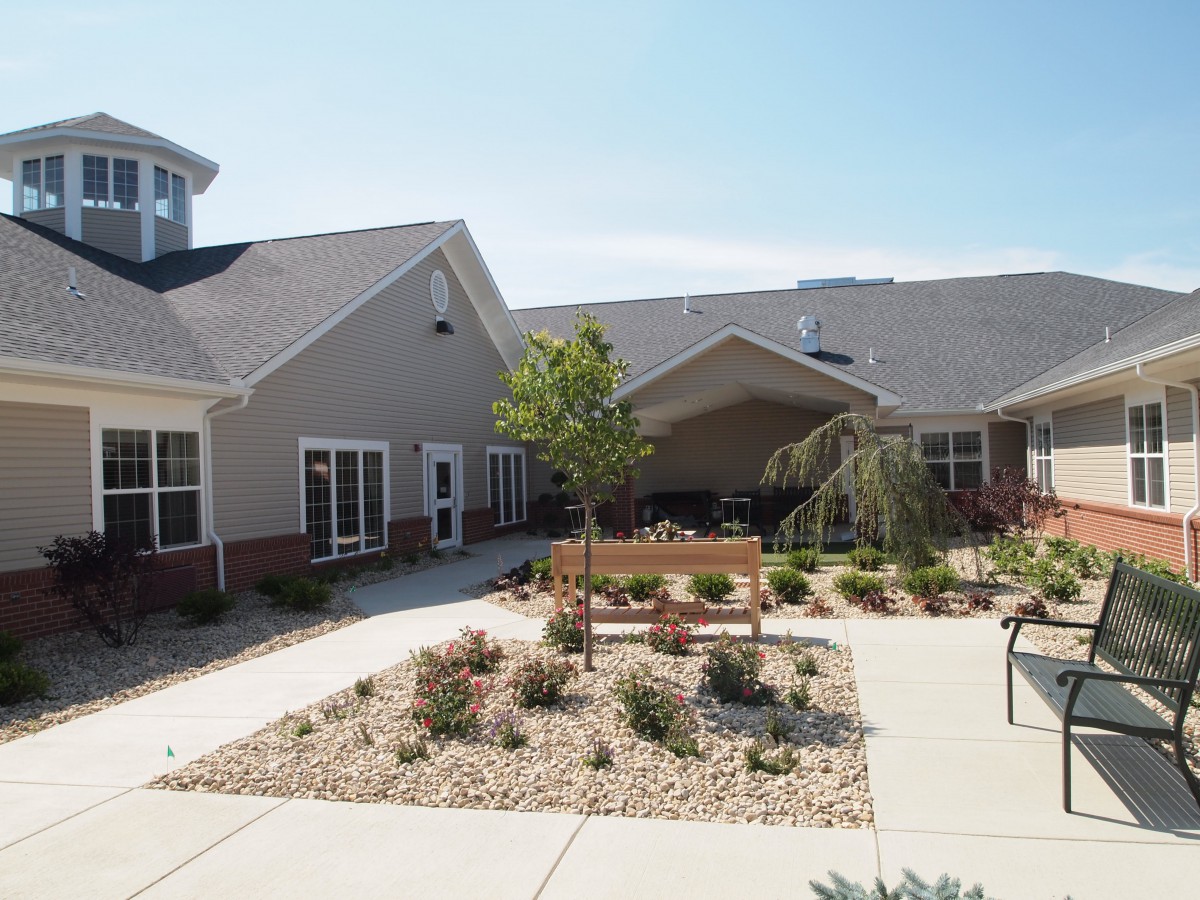 A well-maintained courtyard with landscaping and a modern building in the background.