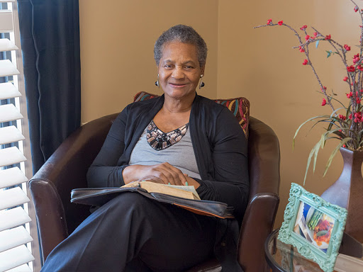 A woman enjoying a moment of relaxation while reading in a cozy indoor setting.