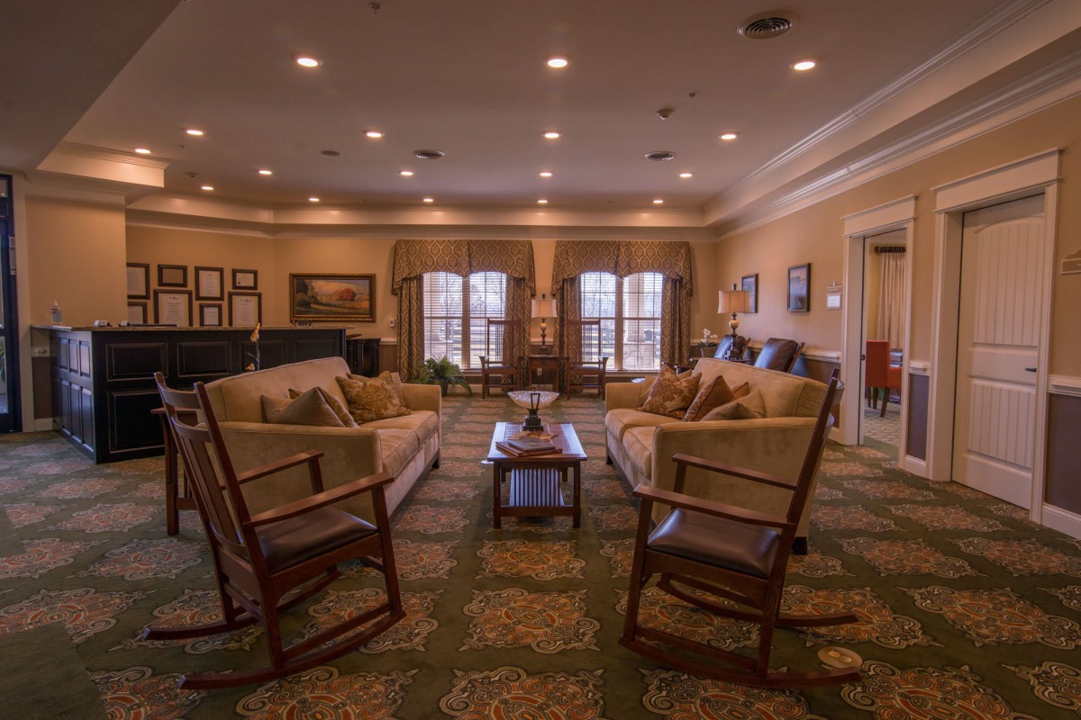 Cozy living room with sofas and chairs arranged around a central coffee table.