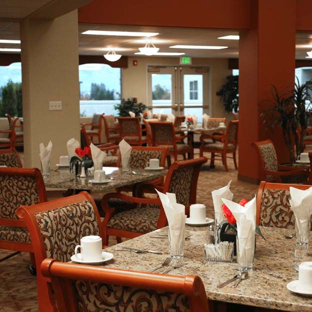 An elegant dining area with neatly set tables and comfortable seating.
