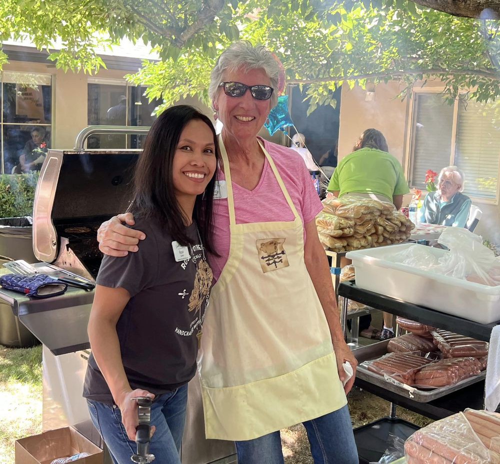 Two people enjoying an outdoor barbecue.