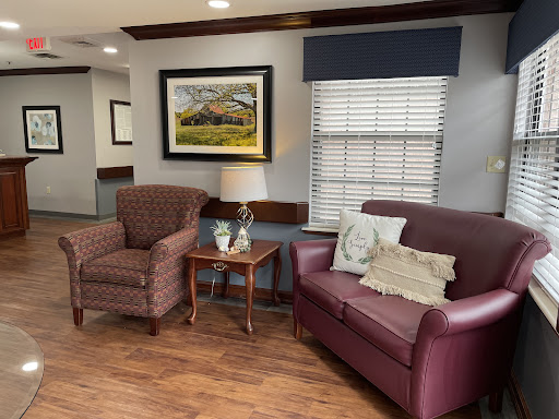 A cozy living room setting with comfortable seating and decorative artwork.