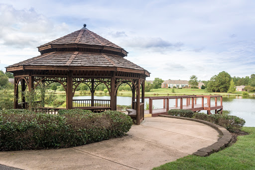 A serene gazebo overlooking a tranquil lake, perfect for relaxation and enjoying nature.