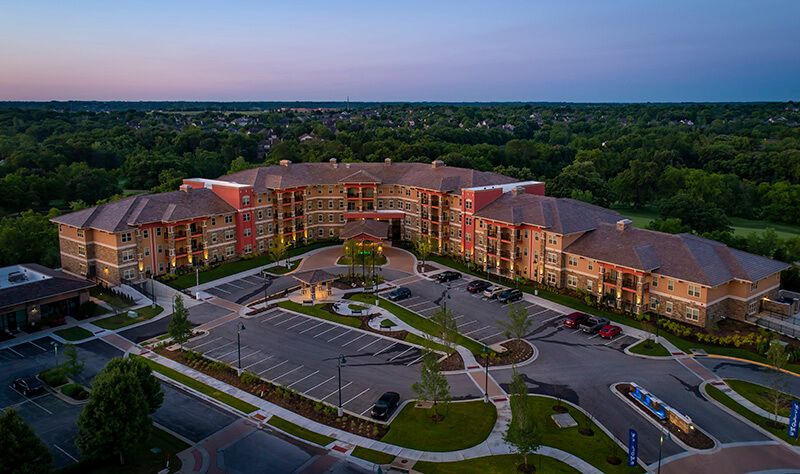 Aerial view of a large residential building complex at sunset.
