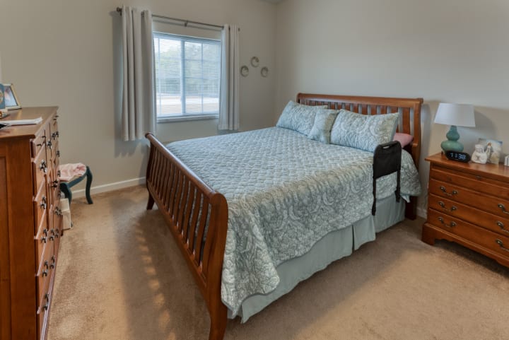 A cozy bedroom with a large wooden bed and soft bedding.