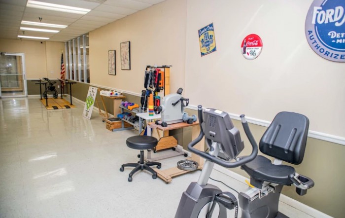 A fitness area featuring stationary exercise bikes and various workout equipment in a well-lit indoor setting.