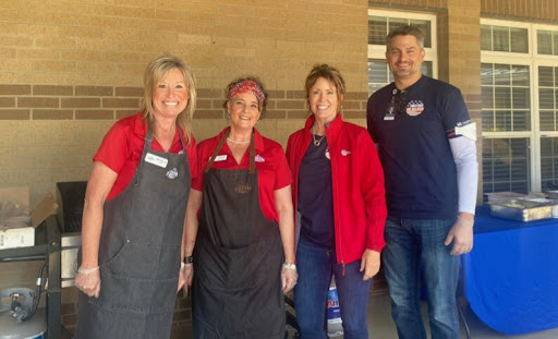 A cheerful group of volunteers posing together at a community event.