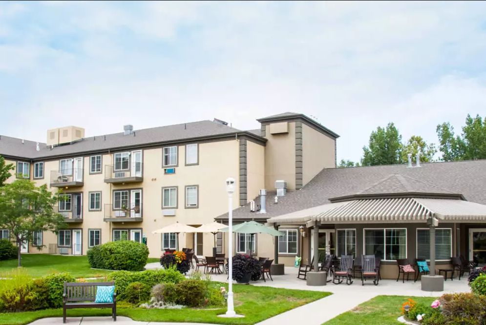 A residential apartment building with an outdoor patio and garden area.