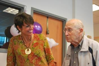 Two people having a conversation at an indoor event.
