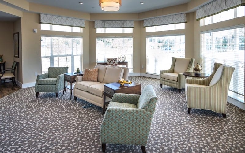A modern living room with comfortable seating and large windows.