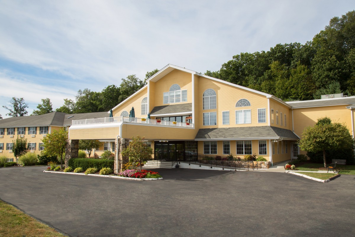 A hotel building with a welcoming entrance and landscaped surroundings.