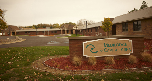 A view of the entrance to a medical facility, featuring a sign indicating its name.