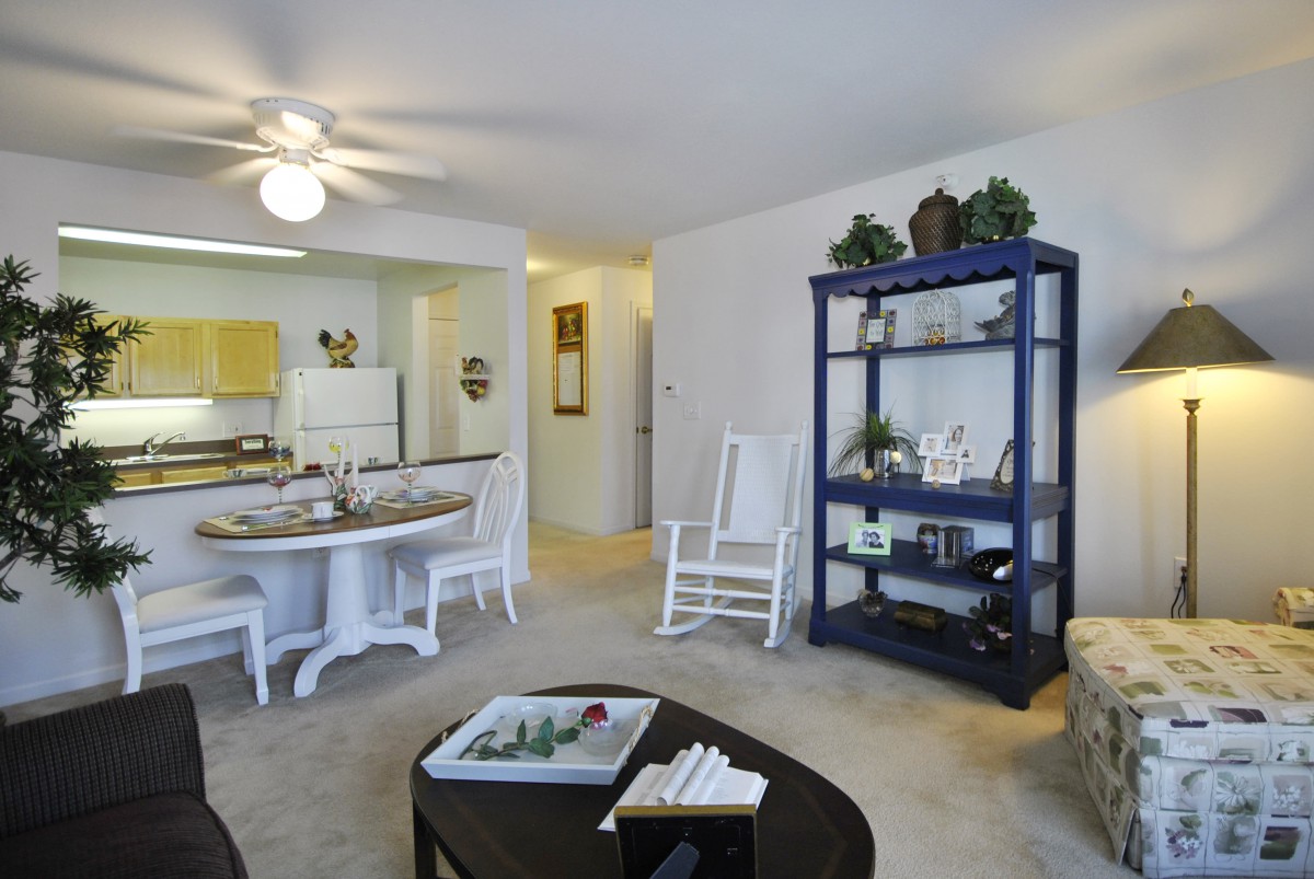A cozy living space with a dining area, kitchen, and tasteful furnishings.