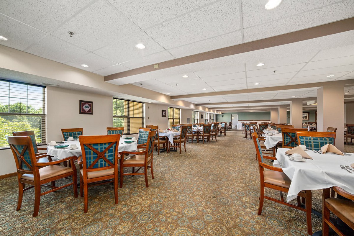 A spacious and elegantly designed restaurant dining area with neatly arranged tables and chairs.